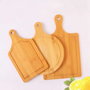 Set of three bamboo pizza chopping boards in round and rectangular shapes with handles, perfect for kitchen prep and pizza serving.