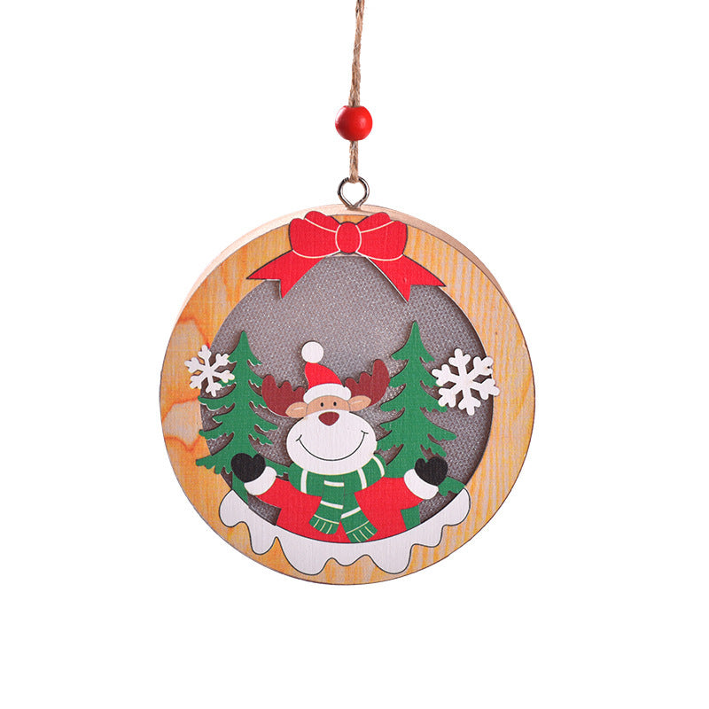 Round wooden New Christmas Tree Pendant with a cheerful reindeer in a scarf, framed by pine trees and snowflakes for Christmas decor.